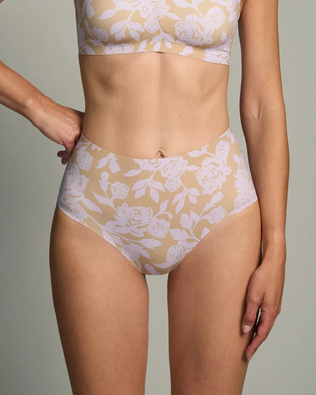 Floral padded wireless bralette and seamless high rise panties set shown on model, featuring a nude base, soft padding, and smooth seamless design for supportive, invisible comfort