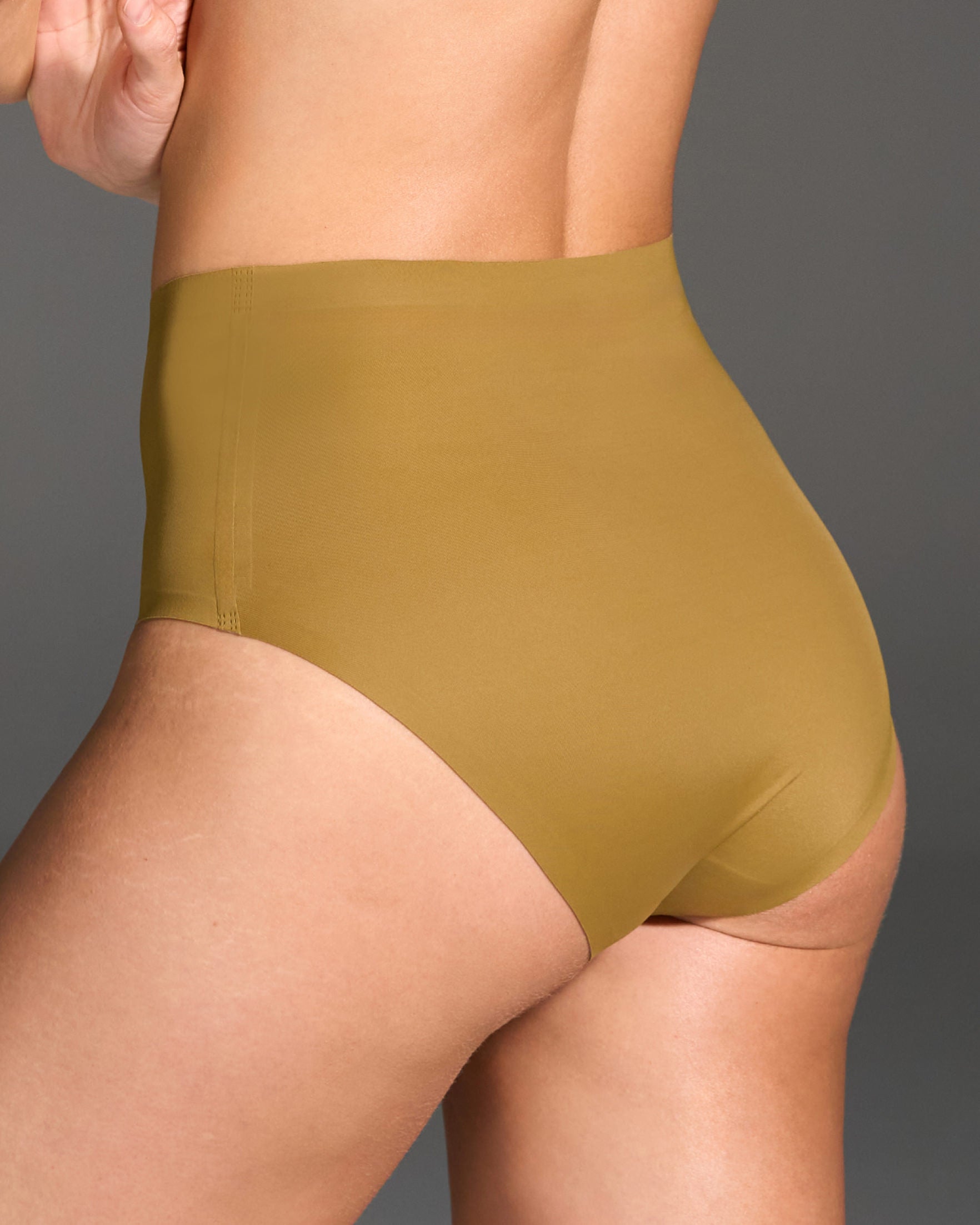 Model wearing Butternut Highwaisted Panties against a gray background